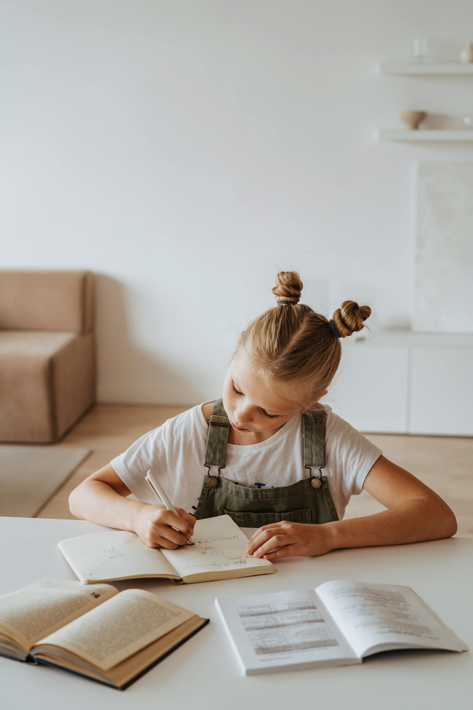 A girl reading at her desk on a scholarship at a partner school